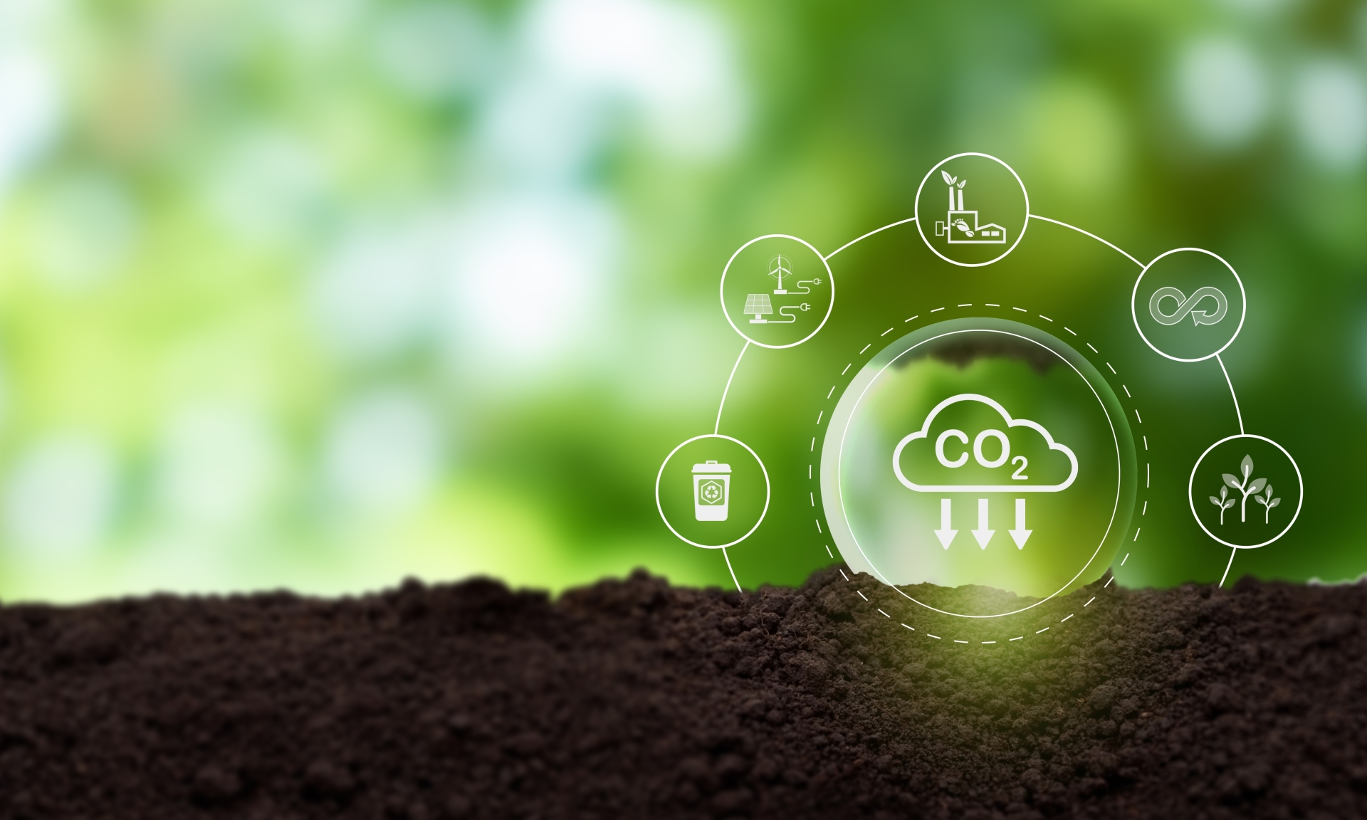 Carbon footprint reduction and sustainability concept with soil, plants, and green technology icons on a blurred green background.